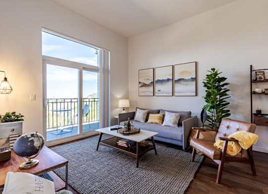 a living room with a couch and a sliding glass door