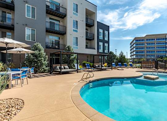 our apartments have a large pool and lounge areas with umbrellas