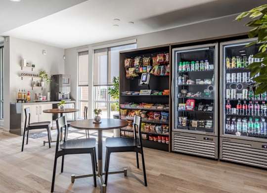 a dining room with a table and chairs in front of a refrigerator