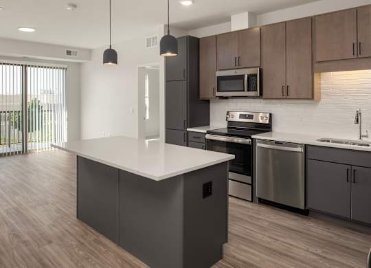 A modern kitchen with a large island in the middle.