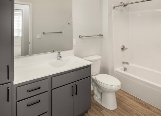 A bathroom with a white toilet and a white sink.
