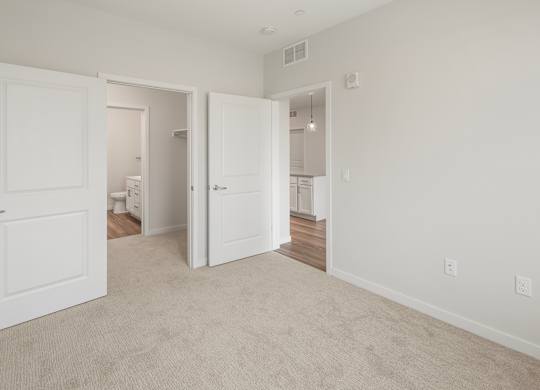 A white door is open to a hallway.
