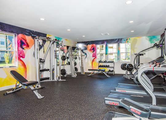 Pet-Friendly Luxury Apartments in Vancouver, WA - Autumn Grove - Fitness Center with Treadmills, Free Weights, Strength Training Equipment, Workout Benches, and Windows.