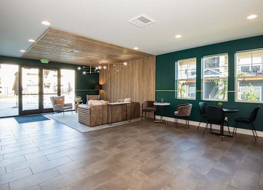 the lobby of a hotel with a reception desk and chairs