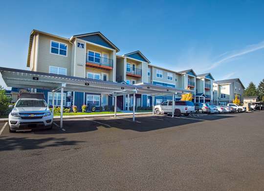 a row of houses with cars parked in front of them