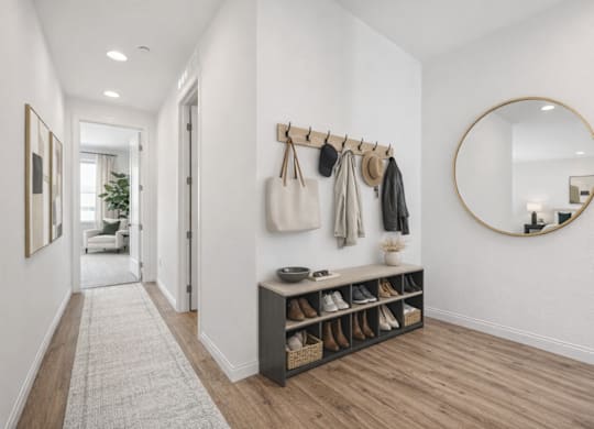 A hallway with a coat rack and a mirror.