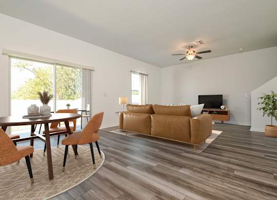 Pet Friendly Homes in Ruskin, FL - Ruskin Reserve - Living Room with wood style flooring, large windows, and ceiling fan