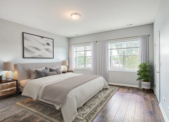 a bedroom with a bed and two windows