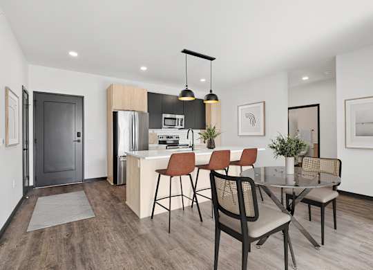 A modern kitchen with a dining table and chairs.