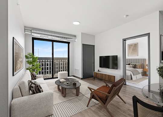 A living room with a couch, chair, and television.