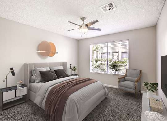 A bedroom with a bed, chair, and a ceiling fan.