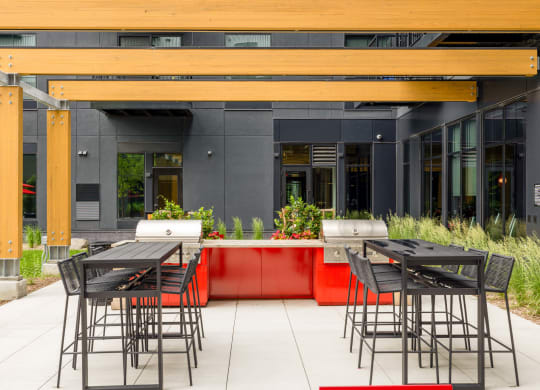 the outdoor seating area of a restaurant with tables and chairs