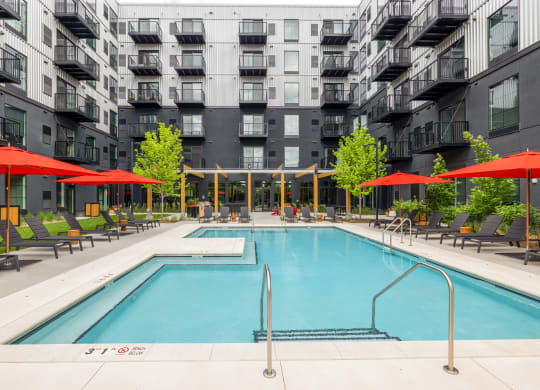 a swimming pool in front of an apartment building