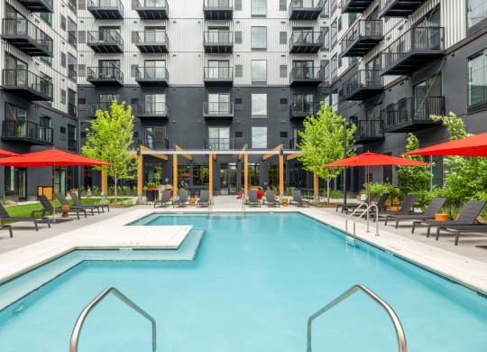 a swimming pool in front of an apartment building