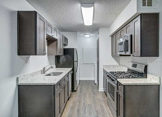 Renovated kitchen with granite countertops at Chelsea Apartments in Gainesville, Florida