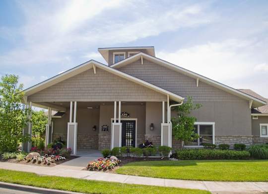 A house with a front porch and a black door.