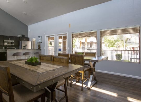 a large dining room with a wooden table and chairs