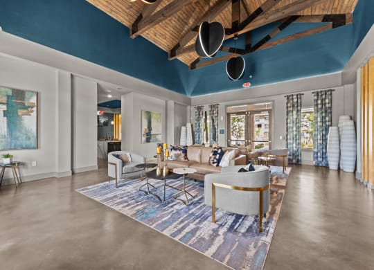 a living room with couches and chairs and a rug