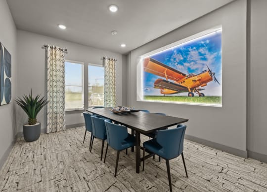 the retreat dining room with table and chairs and a painting of an airplane