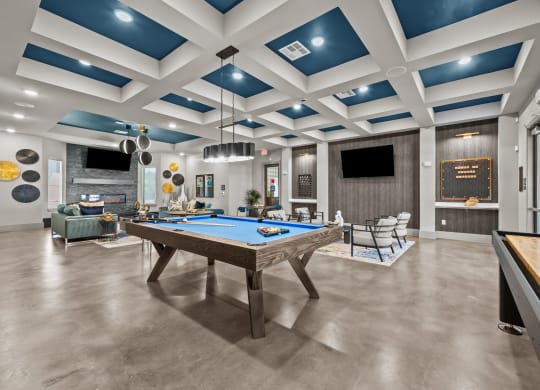a community room with a pool table and couches