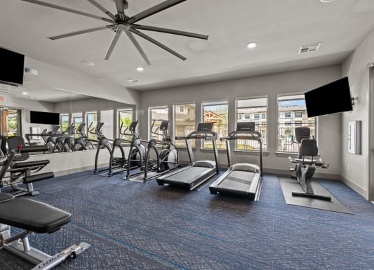 our state of the art fitness center with cardio equipment and windows at our