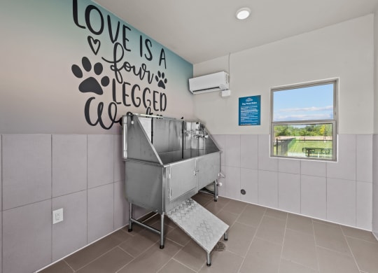 a sink in a room with a wall saying love is a ferris wheel