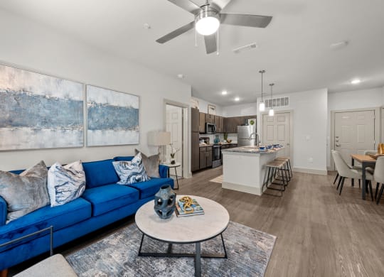 a living room with a blue couch and a table