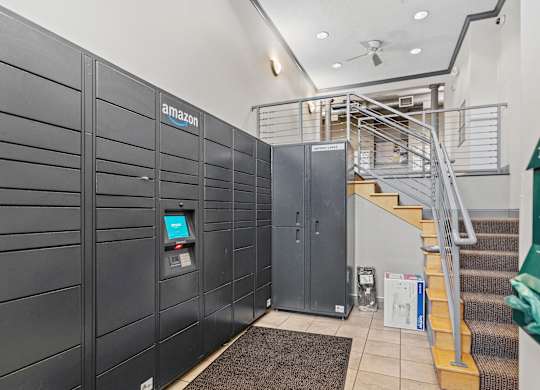 A row of Amazon lockers are lined up in a hallway.