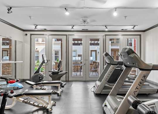 A gym with treadmills and exercise equipment.