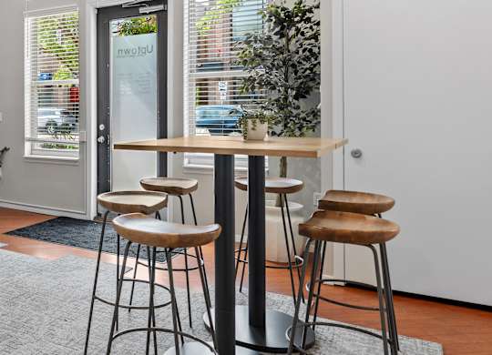 A bar area with a table and two stools.