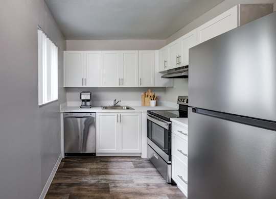 updated kitchen with stainless-style appliances and modern cabinetry at Coronado Springs Apartments in Palm Springs, FL. Spacious pet-friendly apartment home.