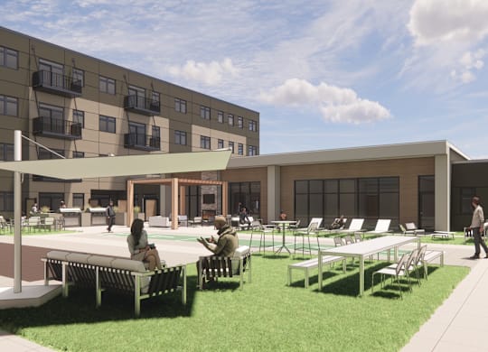 A modern outdoor seating area with people sitting and walking around.