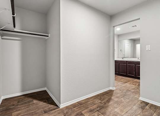 A room with a wooden floor and white walls.