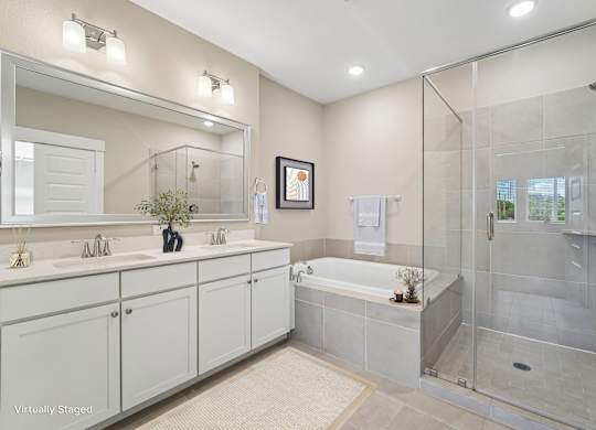 A bathroom with a white tub and a glass shower.