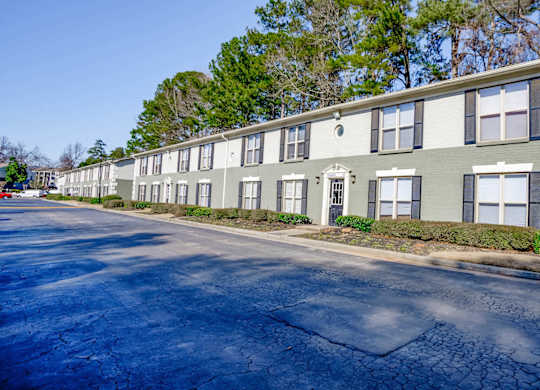 A long building with a green and white exterior.
