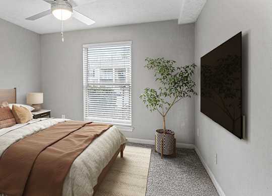 A bedroom with a bed, a ceiling fan, a window with blinds, a lamp, a plant, and a painting on the wall.