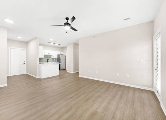 A room with a ceiling fan and light fixture.