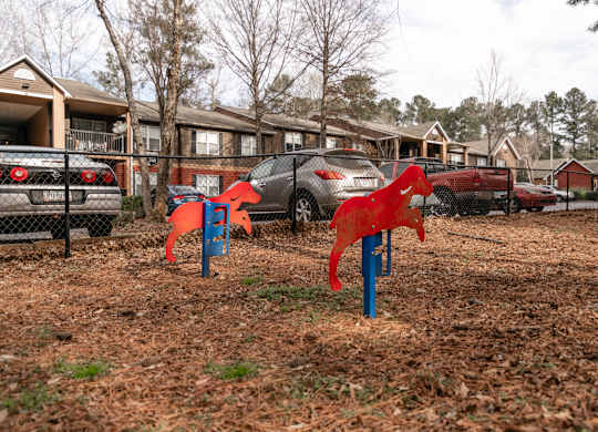 Fenced pet park with agility equipment at Flats at River View apartments in Duluth, GA, near Lawrenceville.