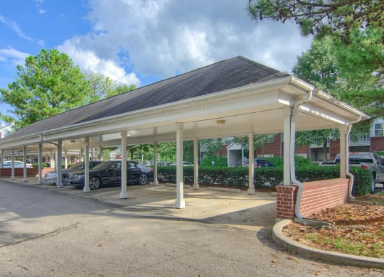 Enclave at Wolfchase Apartments in Cordova Tennessee photo of a covered parking lot with cars parked under it