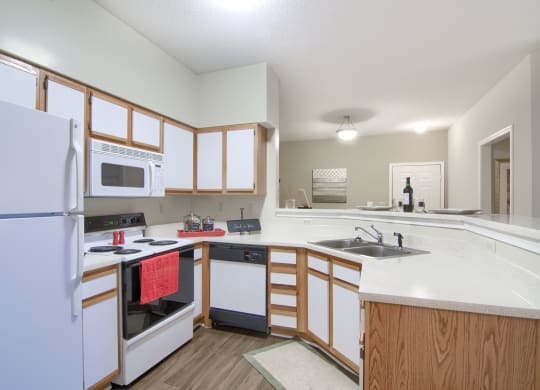 Enclave at Wolfchase Apartments in Cordova Tennessee photo of a kitchen with white cabinets and a white counter top