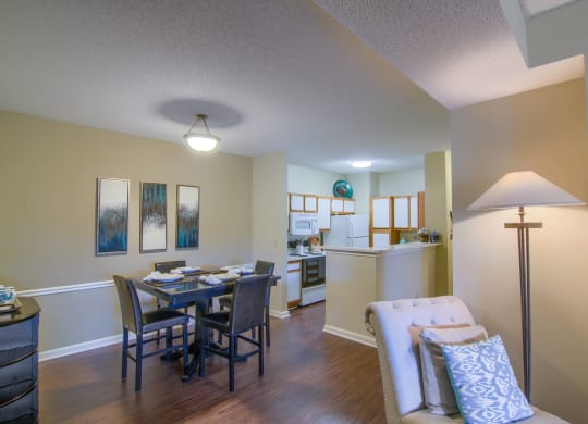 Enclave at Wolfchase Apartments in Cordova Tennessee photo of a living room with a dining room table and a kitchen in the background
