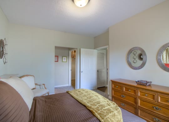 Enclave at Wolfchase Apartments in Cordova Tennessee photo of a bedroom with a bed and a dresser
