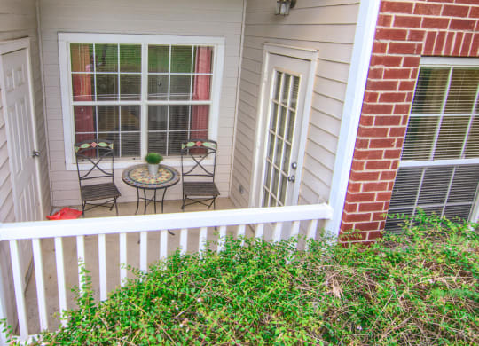 Enclave at Wolfchase Apartments in Cordova Tennessee photo of a small porch with a small table and two chairs