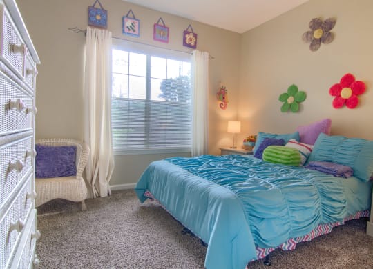 Enclave at Wolfchase Apartments in Cordova Tennessee photo of a bedroom with a bed and a dresser