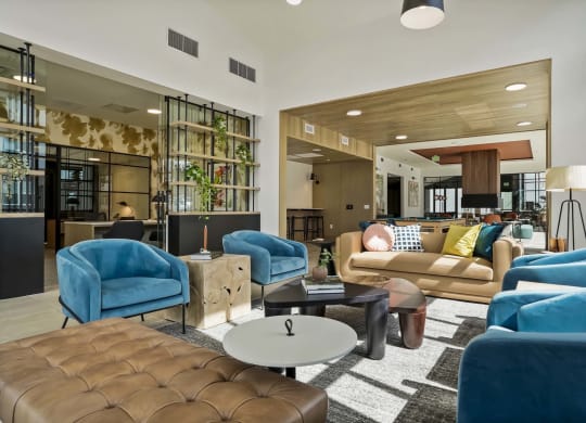 a living room with blue chairs and couches