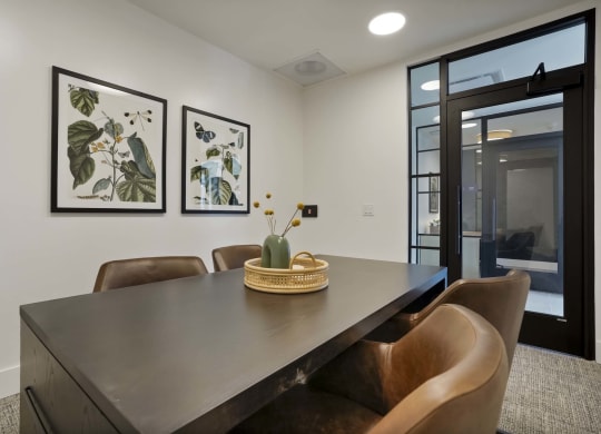 a dining room with a wooden table and chairs