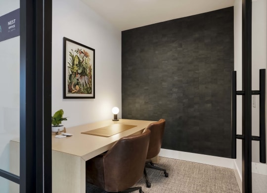 a conference room with a desk and chairs and a black wall