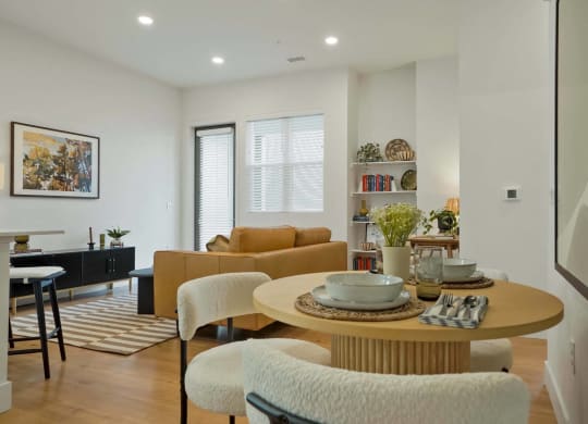 a living room and dining room with a table and chairs