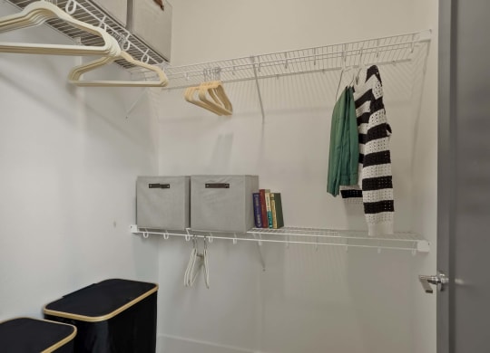 a closet with a rack and two towels on it