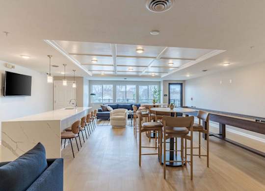 A modern living room with a long wooden table and chairs.
